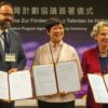 Lora Ho (C), senior vice president of human resources at TSMC, poses with Sebastian Gemkow (L), Saxony state's minister of science, and Ursula Staudinger (R), president of the Dresden University of Technology