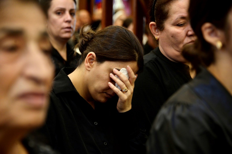 Iraqi mourners attend a mass for the victims of a wedding hall fire at a church in Qaraqosh