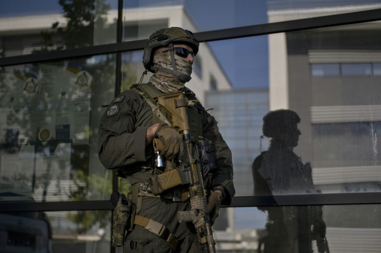 A member of the Kosovo Police Special Intervention Unit secures the entrance of the court, during a session for the arrested Serbian gunmen involved in the recent shootings near the village of Banjska, in Pristina