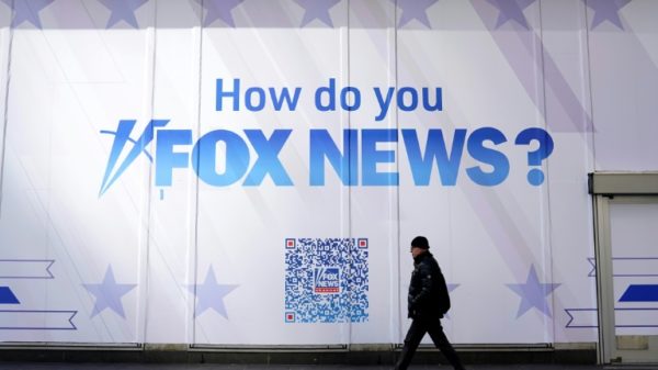 A person walks past the Fox News Headquarters at the News Corporation building in New York City