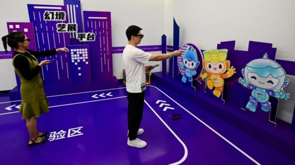 Visitors at the Asian Games eSports venue try out some tech