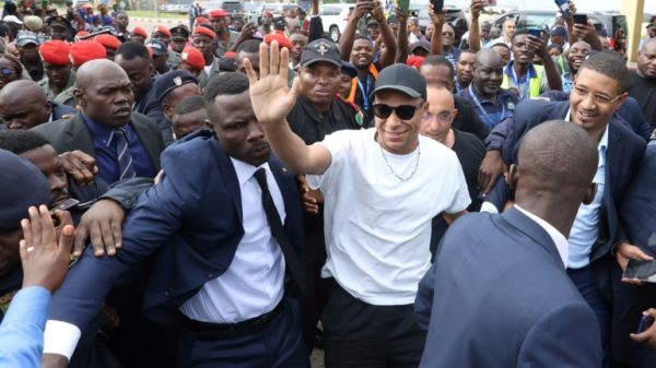 Paris Saint-Germain and France national football team star striker Kylian Mbappe (C) is visiting his father's native Cameroon