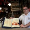 Carlos Fionda, 59, manager of Amazem Sao Thiago bar, shows of the physical menu at the Lapa neighborhood in Rio de Janeiro, Brazil, in May 2023.