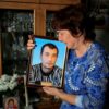 Galina Inkina cries holding a portrait of her late son, Denis, killed in a Kazakh mine