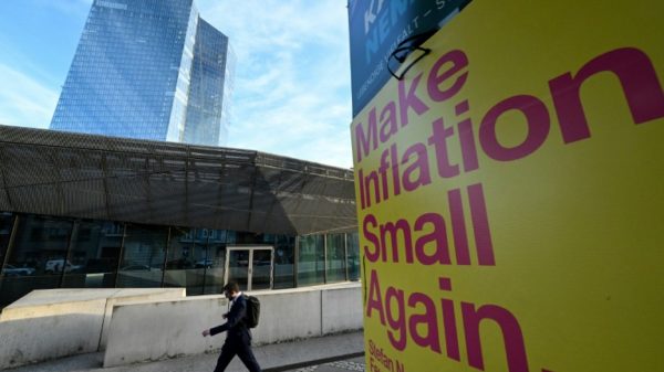 A banner reads "Make Inflation Small Again" next to the European Central Bank building in Frankfurt